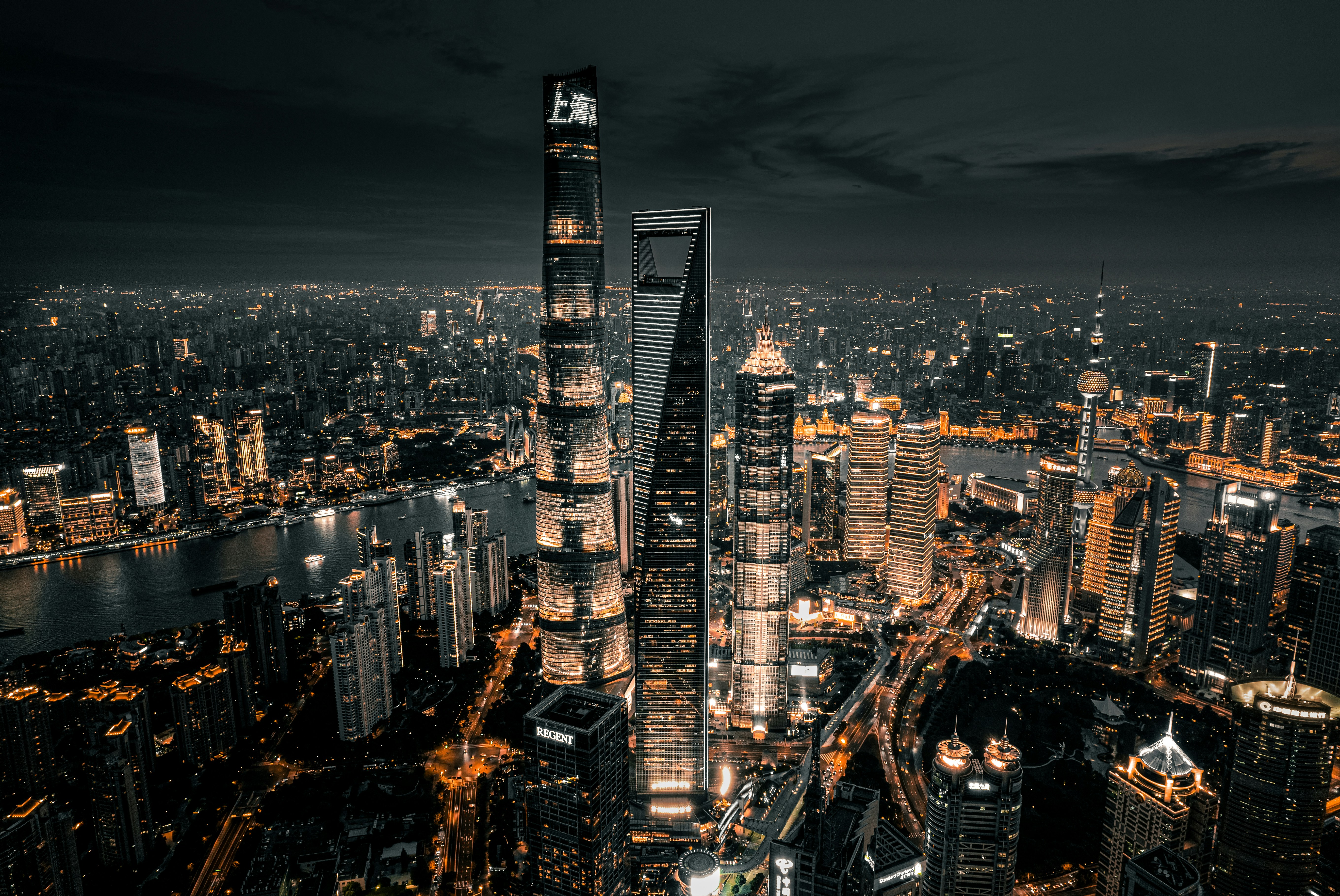 Shanghai skyline at night with the Huangpu River and Pudong towers